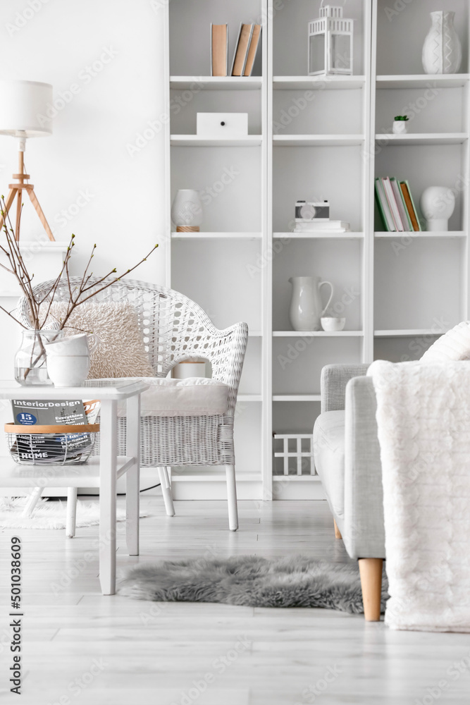 Comfortable sofa, armchair and table in living room interior