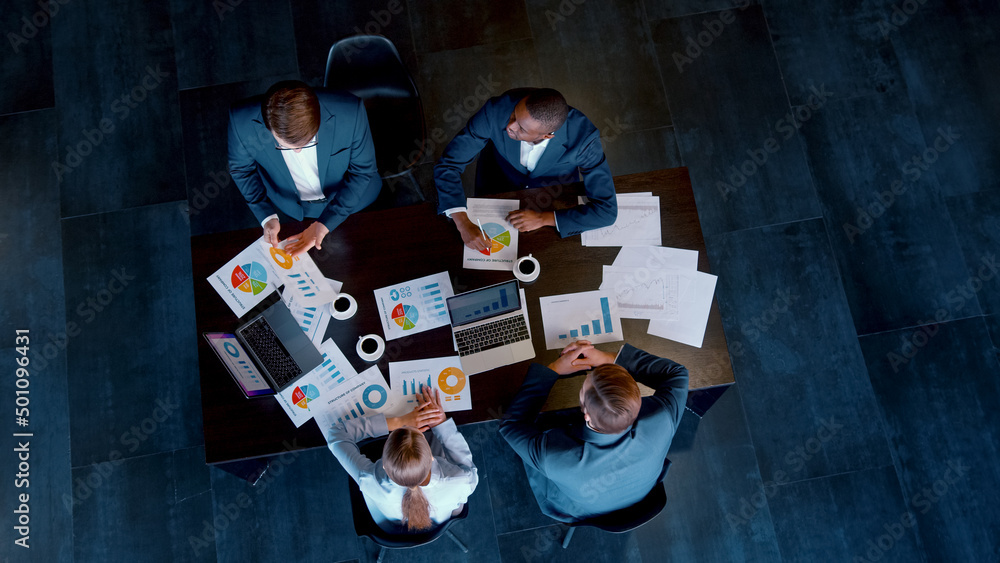 Business people of different ethnicity in a conference room discussing strategy