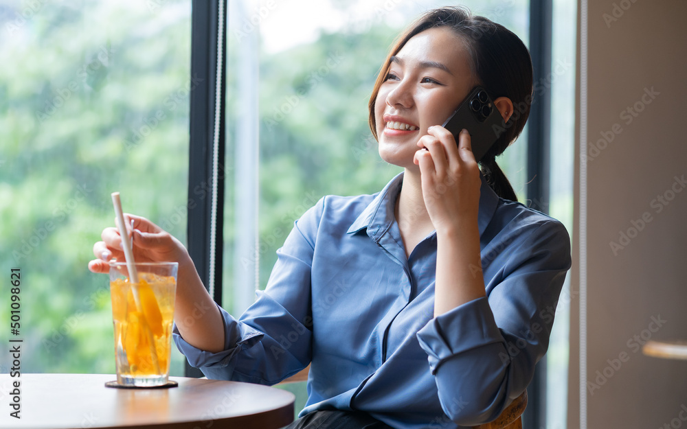 Image of young Asian businesswoman working at coffee shop