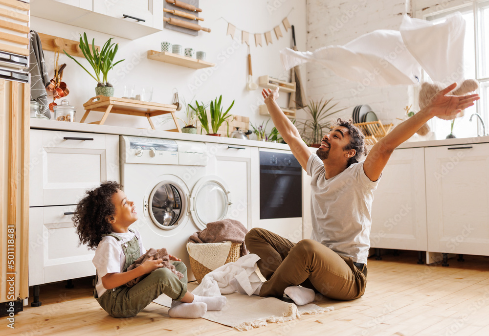 Excited father and kid playing with towels