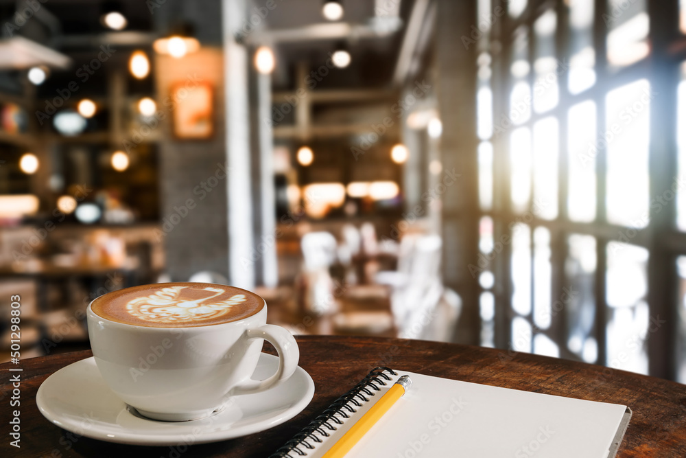  Coffee aroma in cup breakfast morning drink on wooden table in cafe shop with note pad and newspape