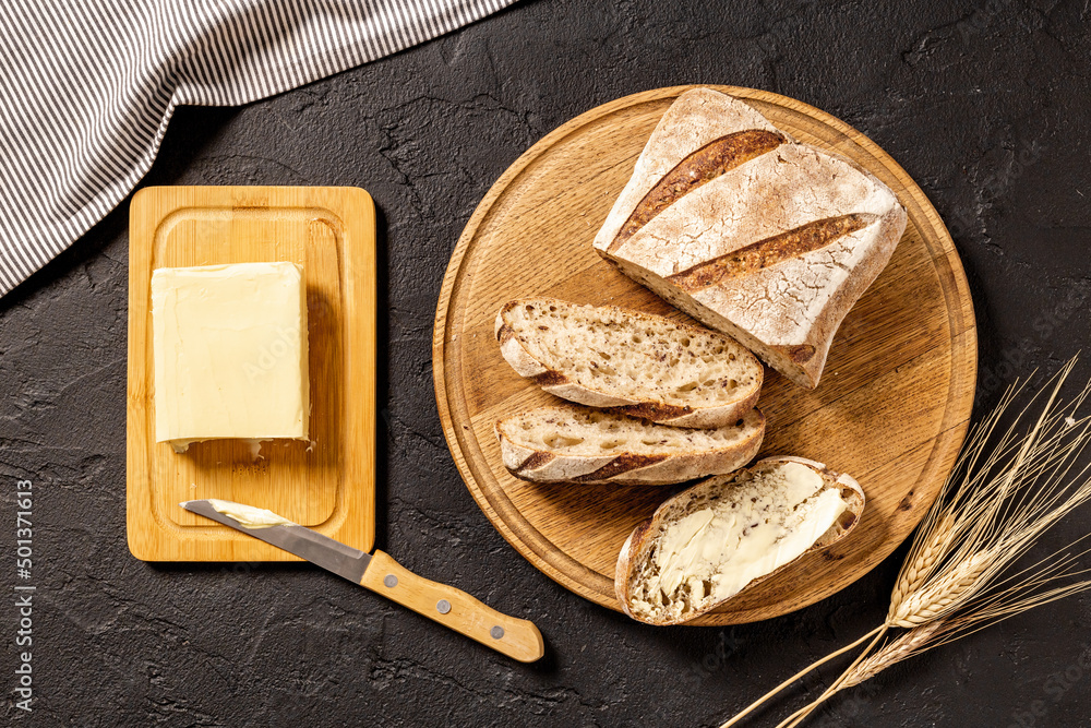 Loaf with dried fruits nuts and butter, top view