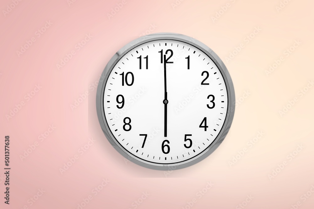 Round clock on pastel background. Wall clock over pink background.