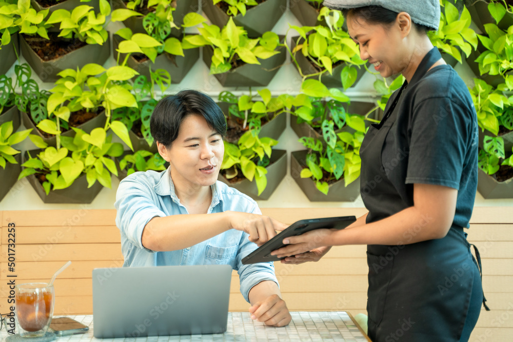 Staff offer the office menu for customers who come to use the service at coffee shop.