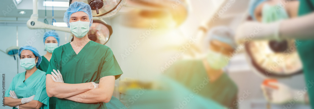 Portrait of Asian men surgeon and nurse with medical mask standing with arms crossed in operation th