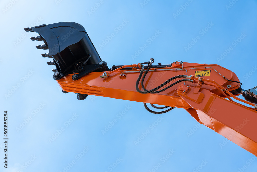 Close up of excavator bucket on a background of blue sky