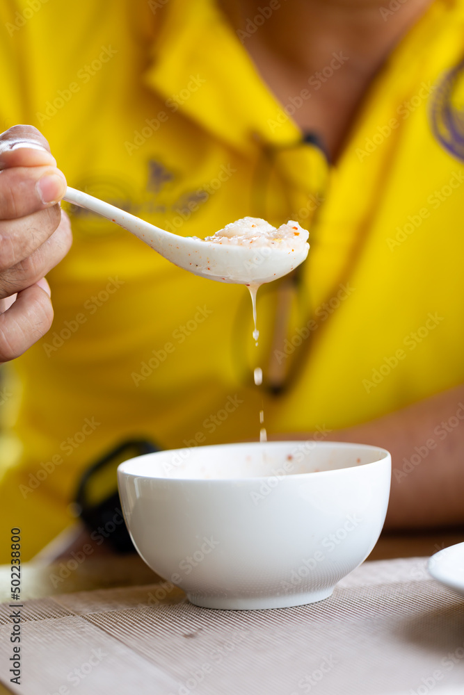 Having homemade pork congee as breakfast in the morning.