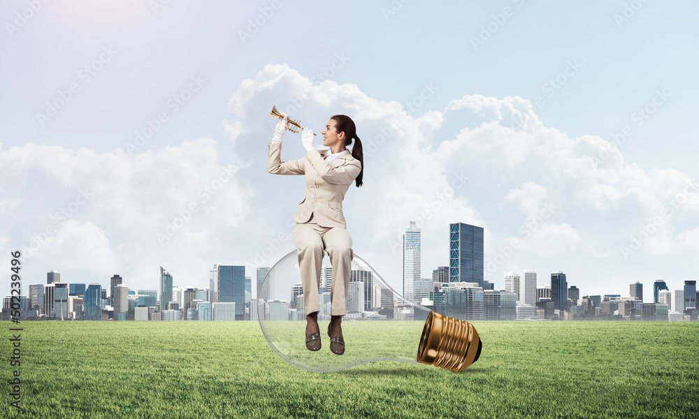 Attractive woman playing trumpet brass