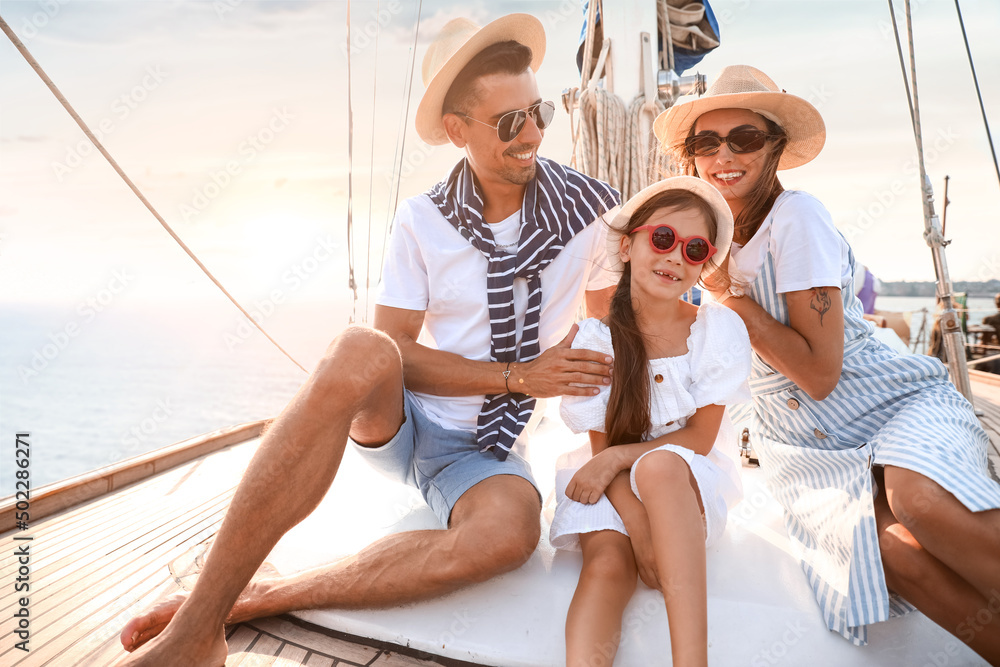 Happy young family resting on yacht