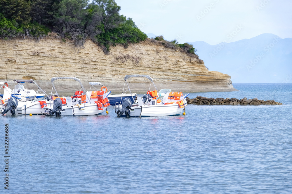 Motor boats with life jackets for tourists at sea resort