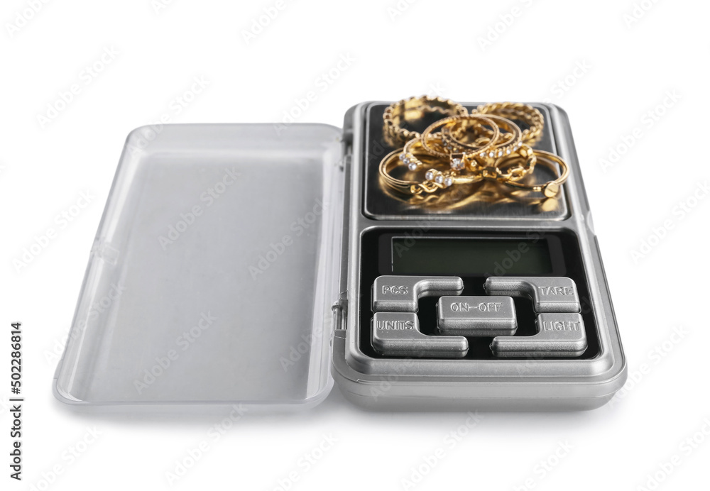 Jewelry scales with rings on white background