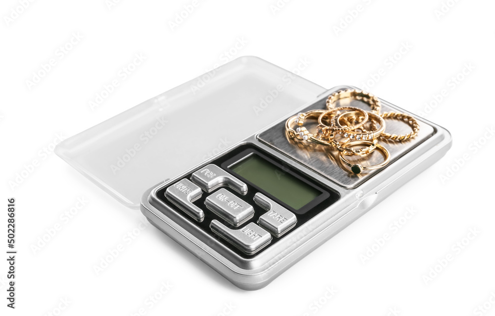 Jewelry scales with rings on white background