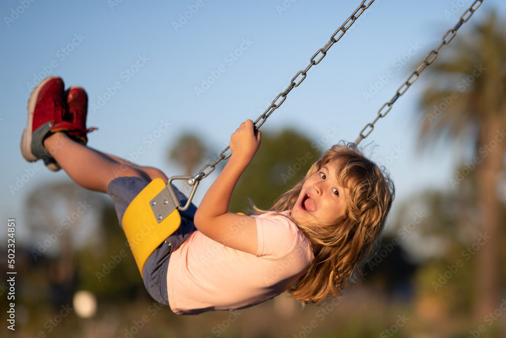 Child boy playing at kids playground. Active little child on playground. Kids play on school or kind