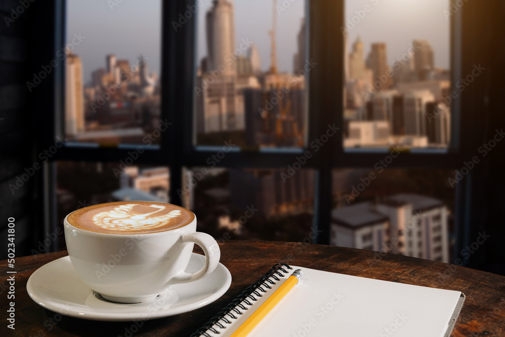  Coffee aroma in cup breakfast morning drink on wooden table in cafe shop with note pad and newspape