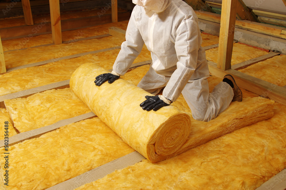 Construction worker thermally insulating house