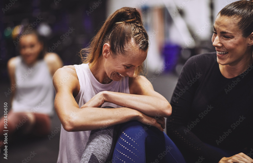 Mature woman laughing with a friend after a gym class