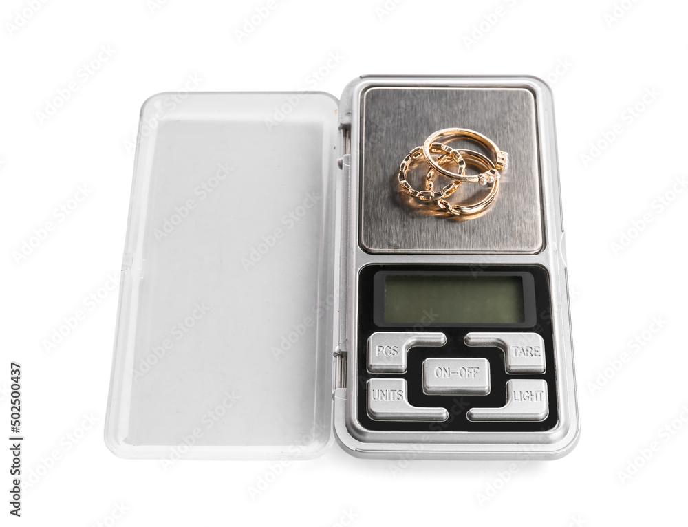 Jewelry scales with rings on white background