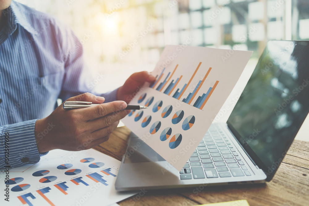 Businessmen are analyze data from report with finance stock market. finance concept.