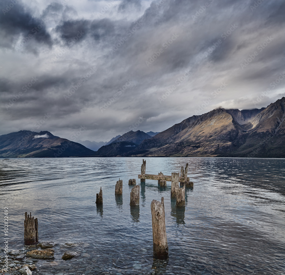 Mountain lake with old ruined pier