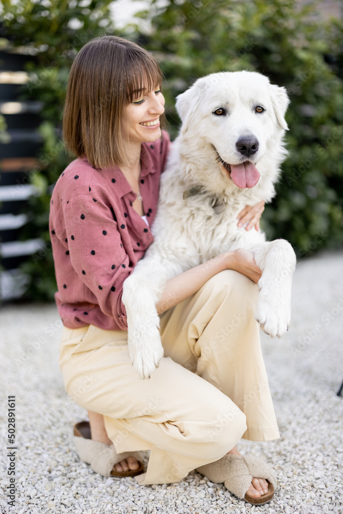 Portrait of a woman with her dog at backyard