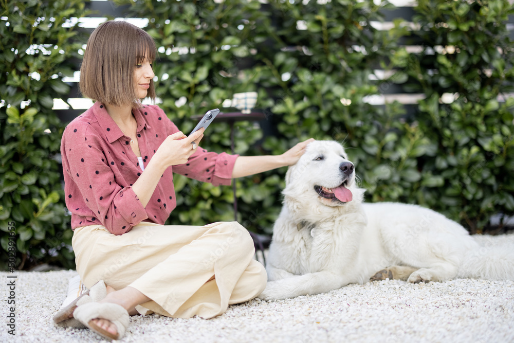 Happy woman with her dog at backyard