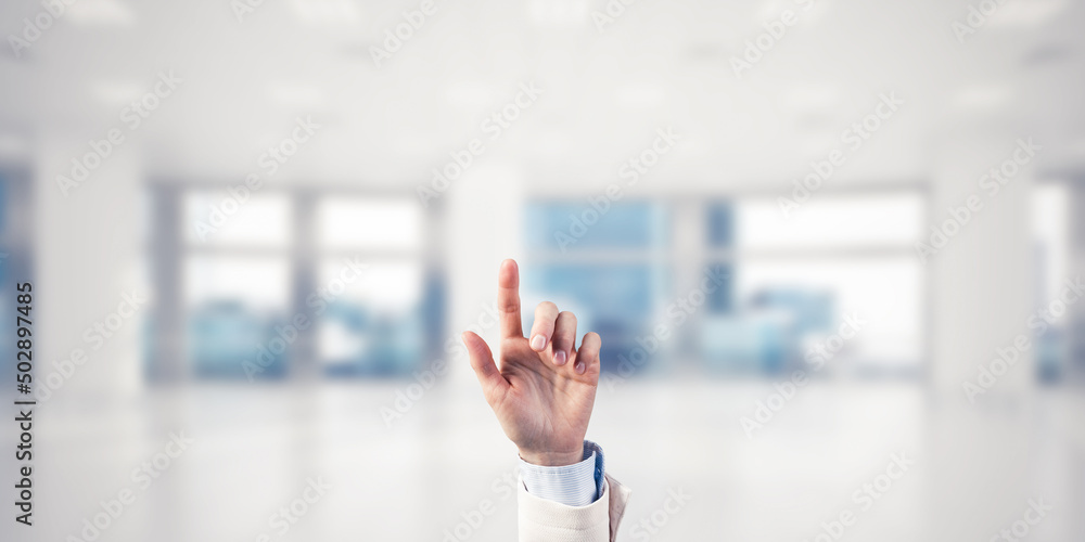 Choosing gesture of businessperson in elegant modern interior in sunshine light