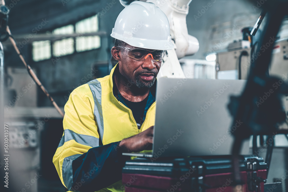 Factory worker working with laptop computer to do adept procedure checklist . Factory production lin