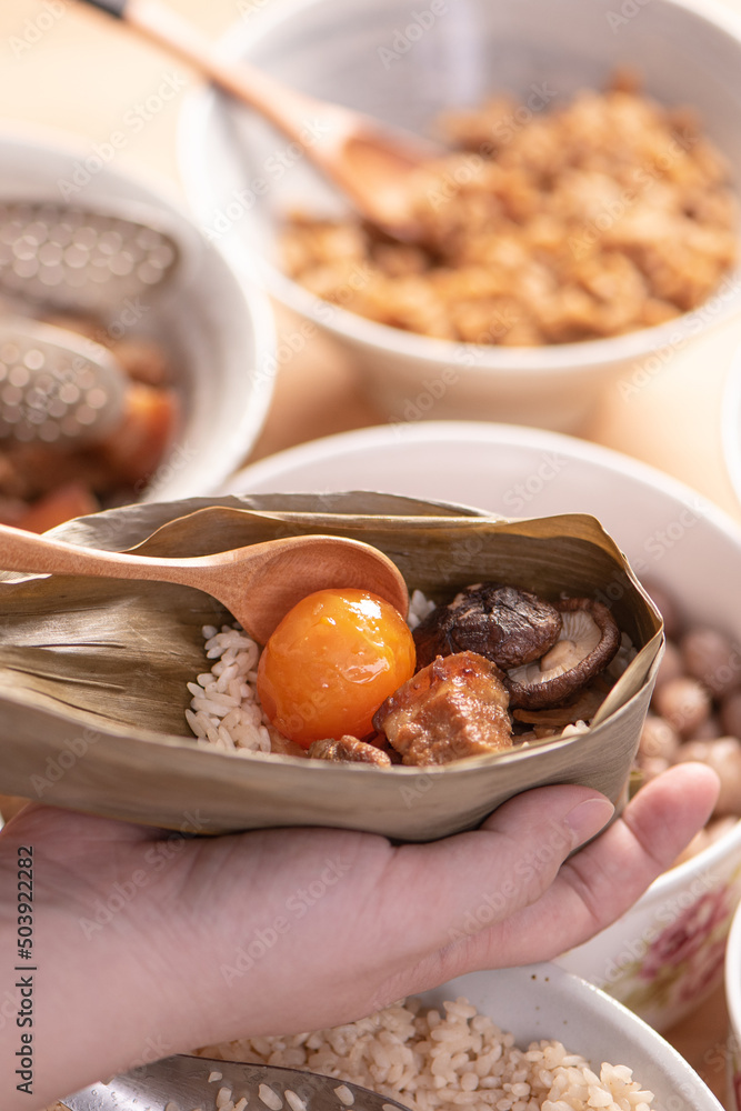 Making zongzi food - preparing and wrapping Chinese rice dumpling.