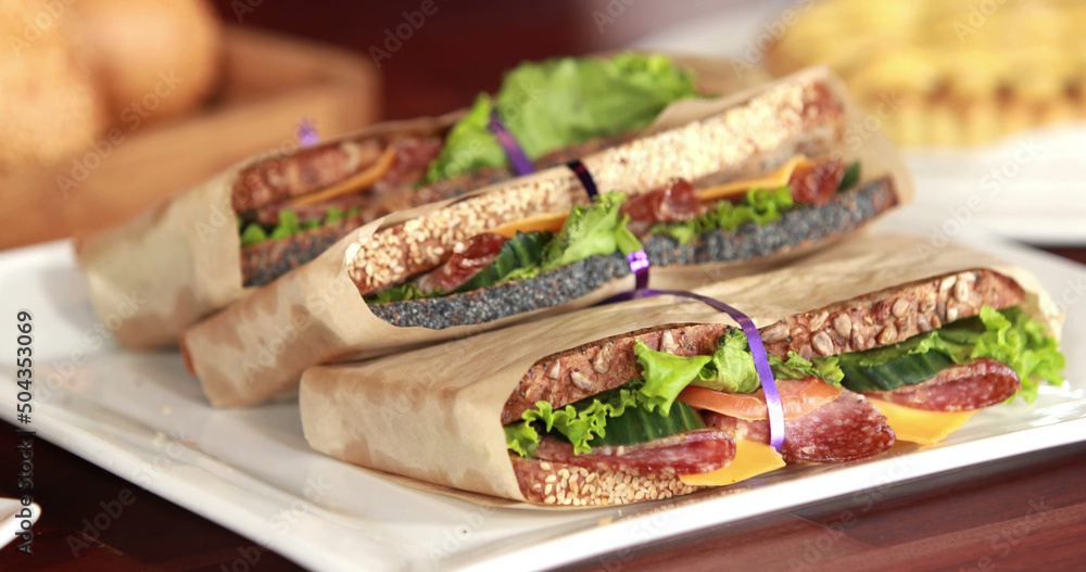 Image of planet earth and hands over fresh organic sandwiches and bread rolls