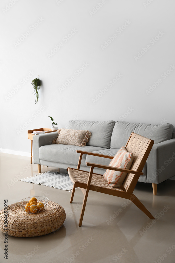 Interior of stylish living room with modern armchair and sofa