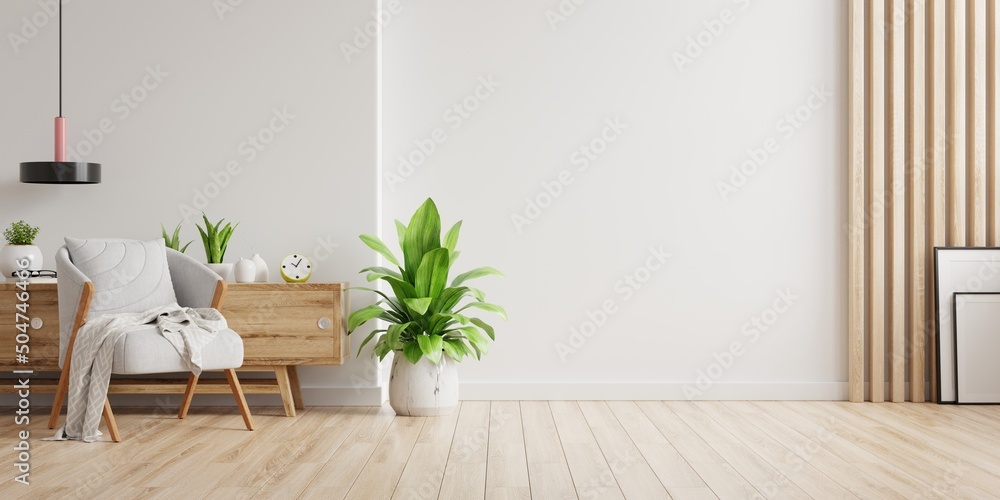 Interior with a gray armchair on empty white wall background.