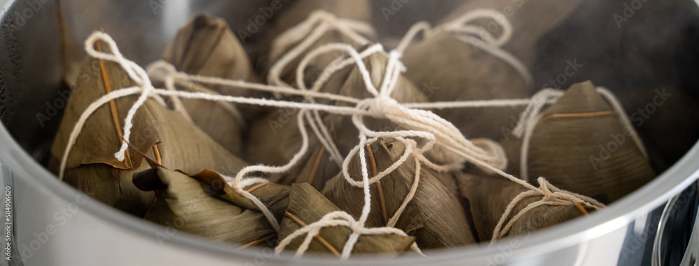 Cooking zongzi food - preparing and steaming Chinese rice dumpling.