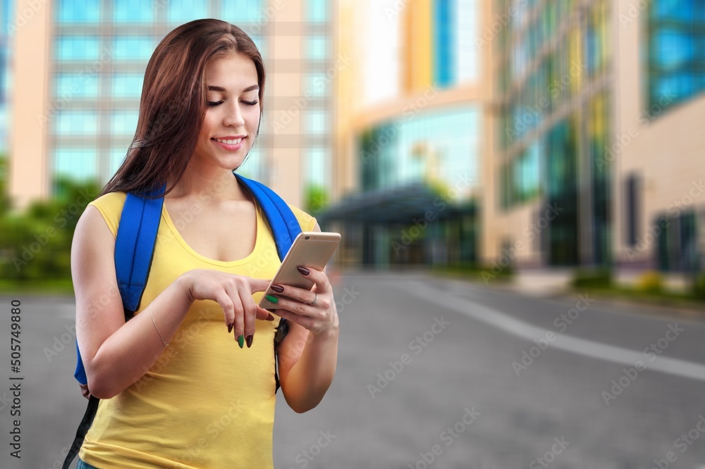 Happy Student Girl Using Phone Standing  on outdoors college Building