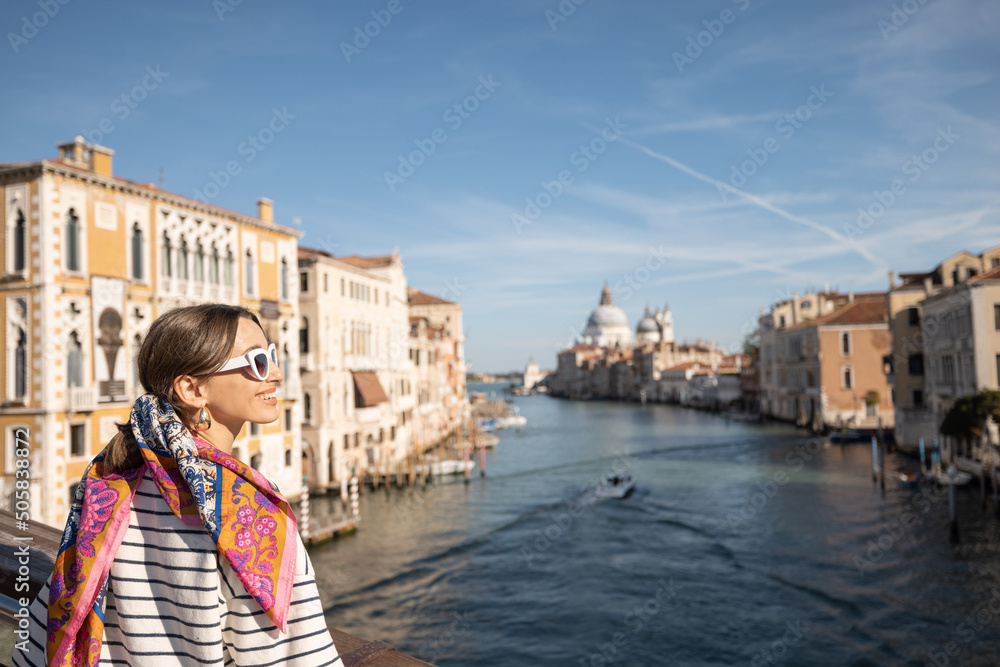 Young woman enjoying beautiful view on Grand Canal from Academy bridge in Venice. Idea of spending s