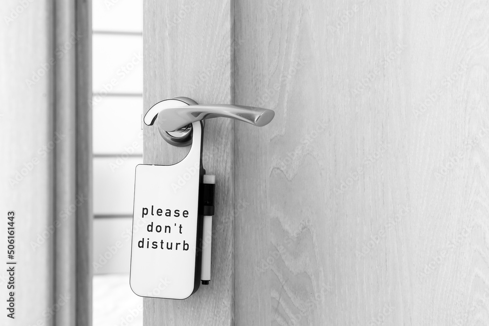 DO NOT DISTURB sign on door of hotel room, closeup