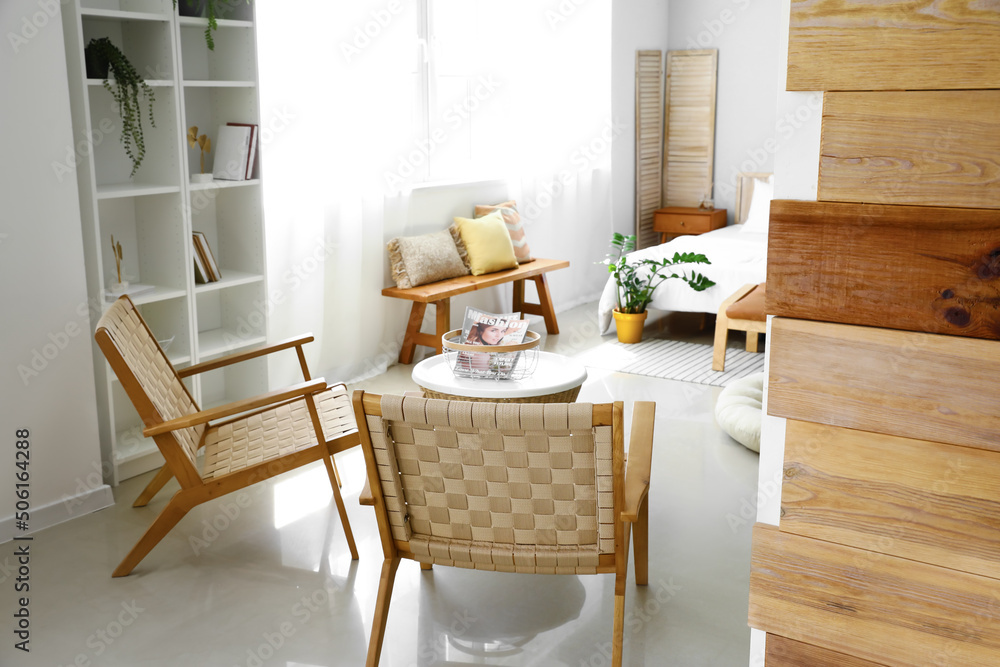 Interior of modern bedroom with stylish armchairs