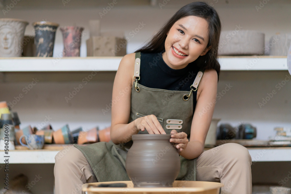 Close up of female hands working on potters wheel,asian female sculpture woman shaping mold small va