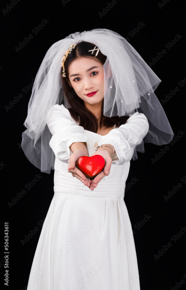 A young woman in a white dress and veil