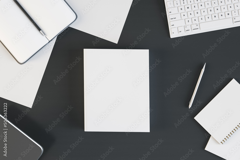 Top view of empty white notebook on black desktop with supplies. Work, diary, homework and workplace