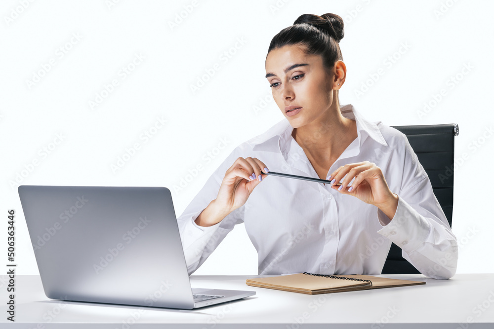 Business process and job concept with pretty young woman sitting at white desk, looking at laptop sc