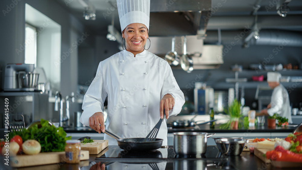 Restaurant Kitchen: Portrait of Black Female Chef in Action, Uses Pan to Cook Delicious, Traditional