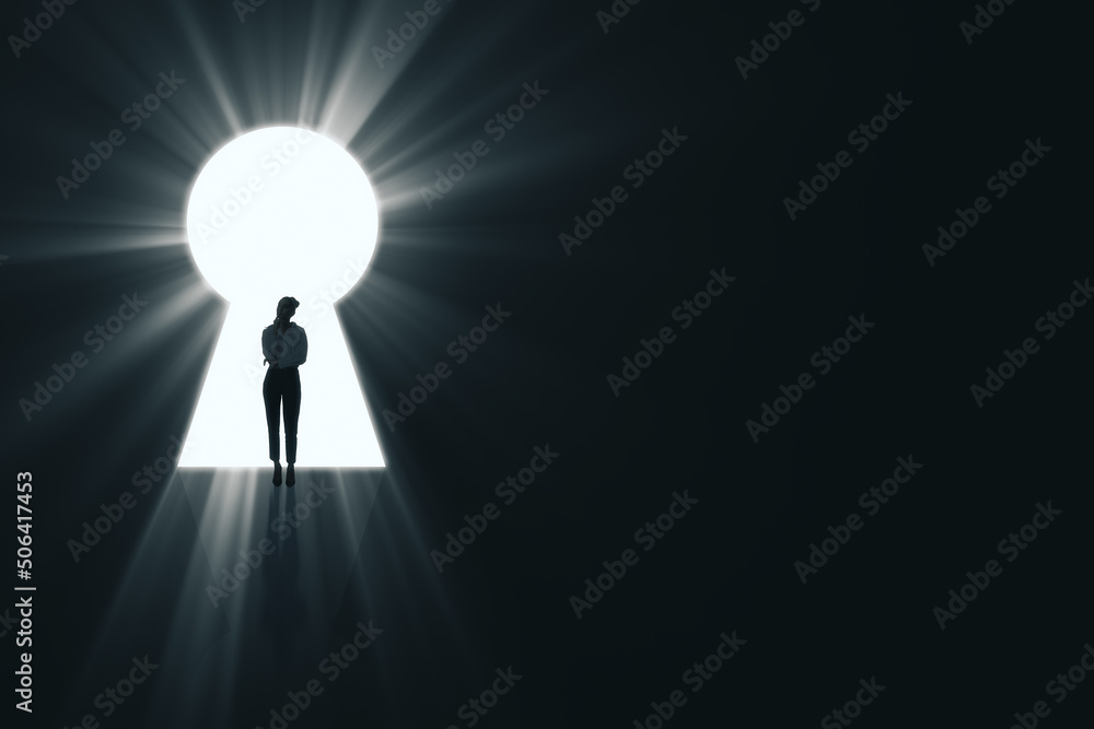 Backlit business woman standing in bright keyhole opening on dark background with mock up place and 