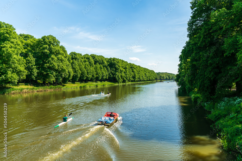 View from the Sachsenbrücke at the Clara-Zetkin-Park in Leipzig, canoeists train on the river