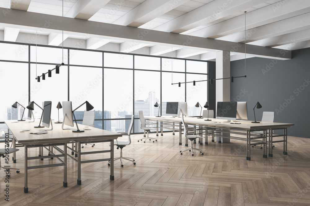 Side view on stylish work places in light spacious office with modern computers, wooden parquet floo