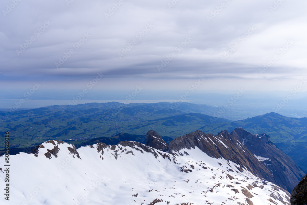 Aerial view with Mountains and midland and lake Bodensee in the background seen from Säntis peak at 