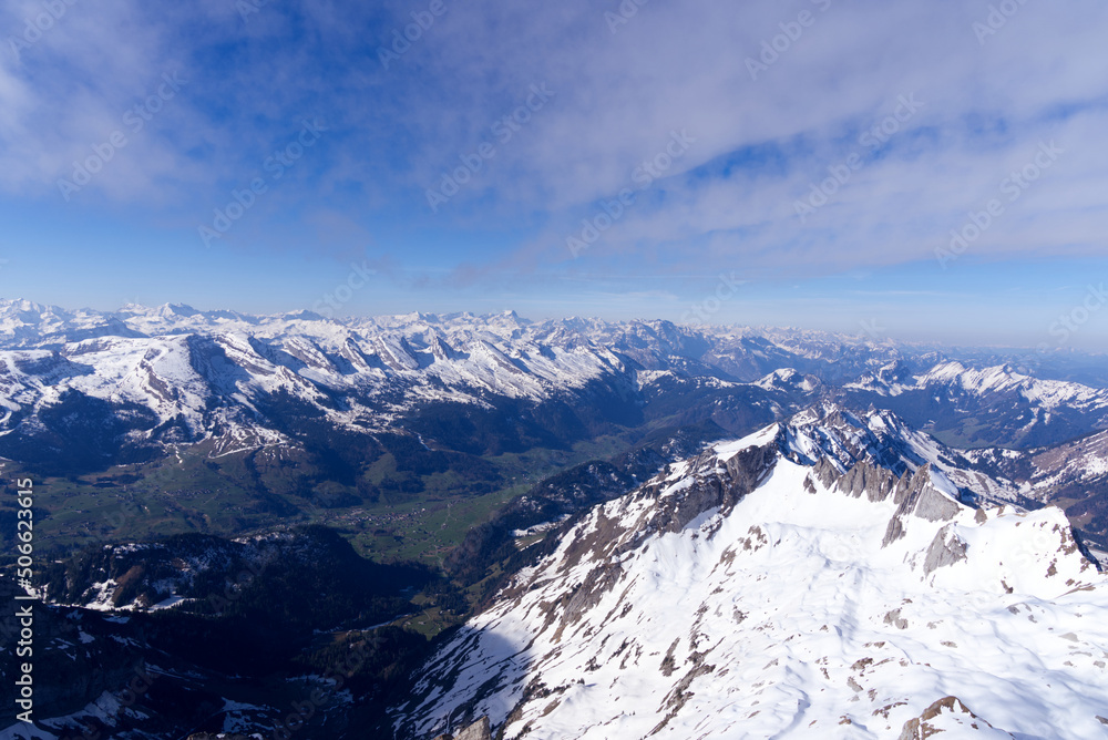 Aerial view over the Swiss Alps seen from Säntis peak at Alpstein Mountains on a sunny spring day. P