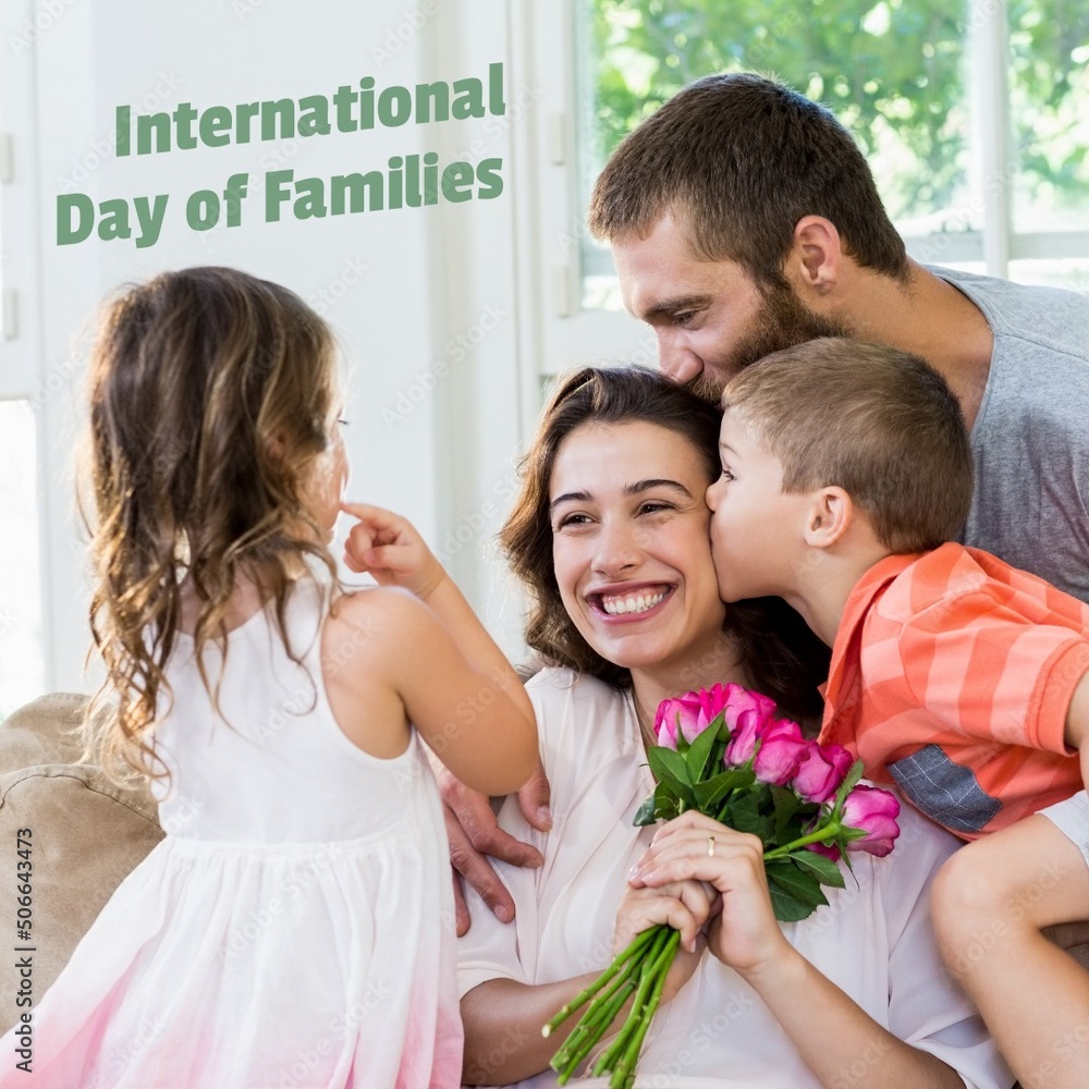 International family day text with happy caucasian family with flowers at home