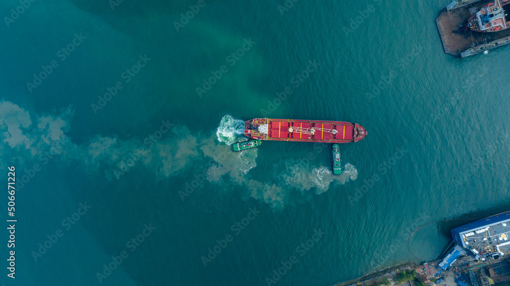 Tug boat drag pull cargo ship from dry dock concept maintenance service 