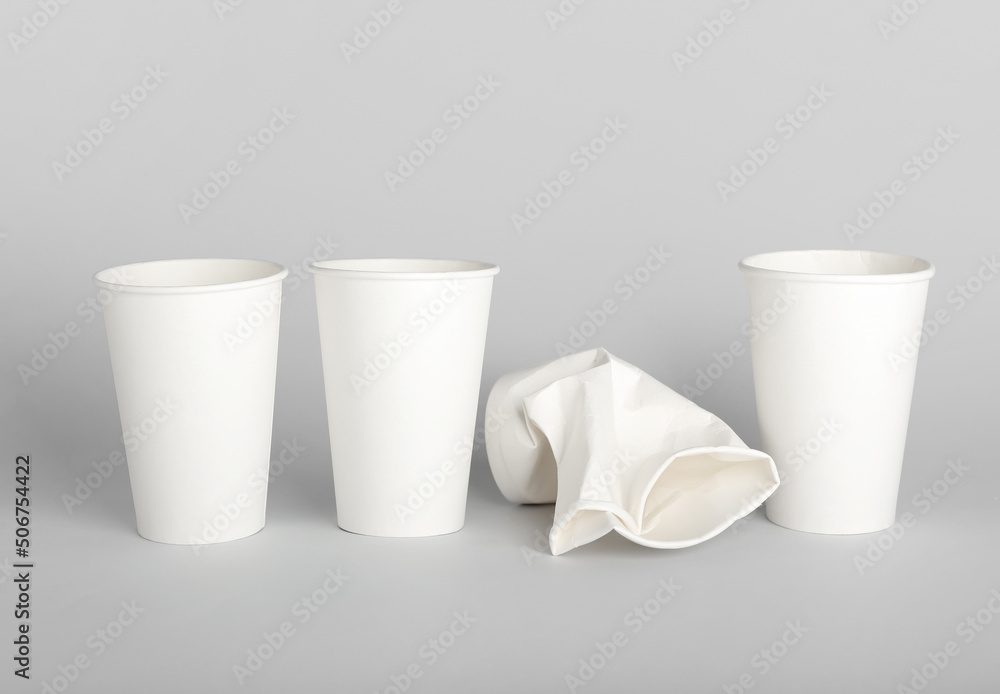 Takeaway paper cups on light background