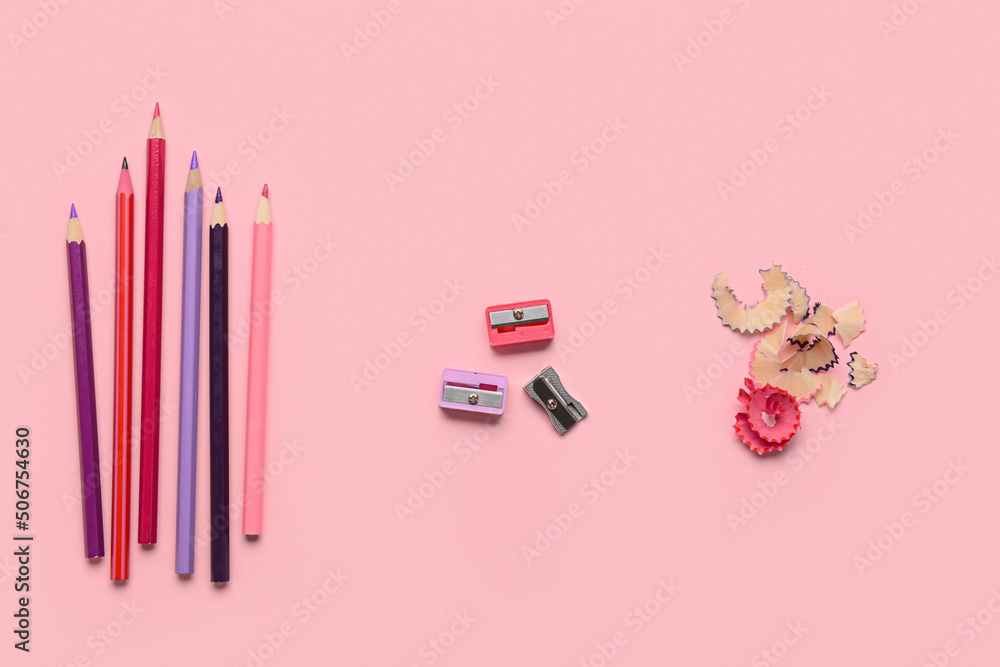 Pencils with sharpeners on pink background